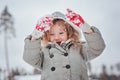 Child girl playing with snow on the walk in winter forest Royalty Free Stock Photo