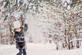 Child girl playing with snow in winter forest Royalty Free Stock Photo