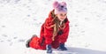 Child girl playing with snow in winter. Kids play in snowy park. Children catch snow flakes. Royalty Free Stock Photo