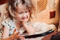 Child girl playing tablet at home Royalty Free Stock Photo