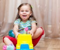 Child girl playing with a toy car