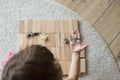 Child girl playing with wooden blocks and toy animals on the floor Royalty Free Stock Photo