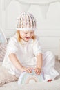 Child girl playing with a wooden toy pyramid. Little cute girl with  natural toys Royalty Free Stock Photo