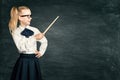 Child Girl Pointing School Blackboard, Pupil Kid in Retro Dress with Pointer over Chalk Board Royalty Free Stock Photo