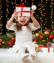 Child girl portrait in christmas decoration, happy emotions, winter holiday concept, dark background with illumination and boke li Royalty Free Stock Photo