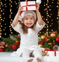 Child girl portrait in christmas decoration, happy emotions, winter holiday concept, dark background with illumination and boke li Royalty Free Stock Photo