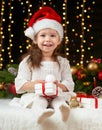 Child girl portrait in christmas decoration, happy emotions, winter holiday concept, dark background with illumination and boke li Royalty Free Stock Photo