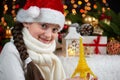 Child girl portrait with eiffel tower and christmas decoration, dark background with lights, face expression and happy emotions, d Royalty Free Stock Photo
