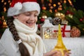 Child girl portrait with eiffel tower figurine and christmas decoration, dark background with lights, face expression and happy em Royalty Free Stock Photo