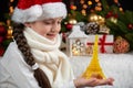 Child girl portrait with eiffel tower figurine and christmas decoration, dark background with lights, face expression and happy em Royalty Free Stock Photo