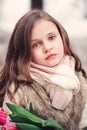 Child girl portrait with flowers on cozy warm outdoor winter walk