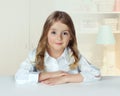 Child girl portrait indoor home.Pupil female at table.Lifestyle.