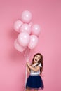 Child girl posing with pastel pink air balloons Royalty Free Stock Photo