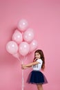 Child girl posing with pastel pink air balloons Royalty Free Stock Photo