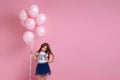 Child girl posing with pastel pink air balloons Royalty Free Stock Photo