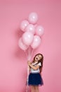 Child girl posing with pastel pink air balloons Royalty Free Stock Photo