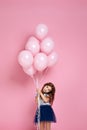 Child girl posing with pastel pink air balloons Royalty Free Stock Photo