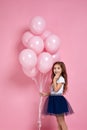 Child girl posing with pastel pink air balloons Royalty Free Stock Photo