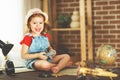 Child girl preparing to travel with a card and photo camera Royalty Free Stock Photo