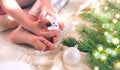 Child girl preparing  winter holidays and Christmas at home. She sitting on floor and playing with Christmas toys. Happy New Year Royalty Free Stock Photo