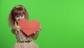 Child girl princess holds red paper heart with text about mother. Mother`s day Royalty Free Stock Photo