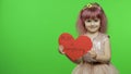 Child girl princess holds red paper heart with text about mother. Mother`s day Royalty Free Stock Photo