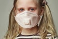 Child girl in protective medical mask crying, closeup portrait