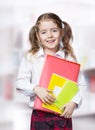 Child girl pupil stand hold folder book in white shirt. Royalty Free Stock Photo