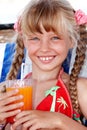 Child girl in red bikini drink juice. Royalty Free Stock Photo