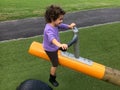 Child girl rides on Seesaw