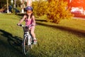 Child girl riding bicycle on summer sunset in the park. Royalty Free Stock Photo