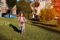 Child girl riding bicycle on summer sunset in the park. Royalty Free Stock Photo