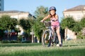 Child girl riding bicycle on summer sunset in the park. Royalty Free Stock Photo