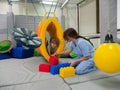 Child girl in roller tonnel during sensory integration session