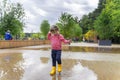 child girl running and jumping in puddles after rain in summer Royalty Free Stock Photo