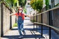 Child girl running outdoors wearing a protection mask against coronavirus during Covid-19 pandemic Royalty Free Stock Photo