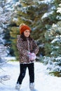 Child girl running and playing with snow in the winter forest, bright snowy fir trees, beautiful nature Royalty Free Stock Photo