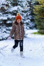 Child girl running and playing with snow in the winter forest, bright snowy fir trees, beautiful nature Royalty Free Stock Photo