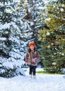 Child girl running and playing with snow in the winter forest, bright snowy fir trees, beautiful nature Royalty Free Stock Photo