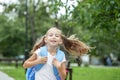 Child girl runs and smiles. Schoolgirl with backpack. The concept of school, study, education, friendship Royalty Free Stock Photo