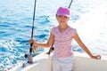 Child girl sailing in fishing boat holding rod Royalty Free Stock Photo