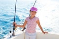 Child girl sailing in fishing boat holding rod Royalty Free Stock Photo