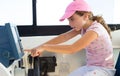 Child girl sailing steering the boat wheel Royalty Free Stock Photo