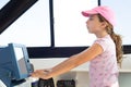 Child girl sailing steering the boat wheel Royalty Free Stock Photo