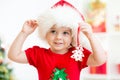 Child girl in Santa hat holding Christmas cookies Royalty Free Stock Photo