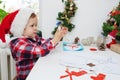 Child girl in Santa hat making christmas card from paper at home Royalty Free Stock Photo