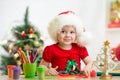 Child girl in Santa hat making christmas Royalty Free Stock Photo