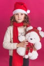 Child girl in santa hat on red background Royalty Free Stock Photo
