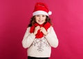 Child girl in santa hat on red background Royalty Free Stock Photo