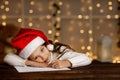 Child girl in santa hat writing letter to Santa Claus Royalty Free Stock Photo